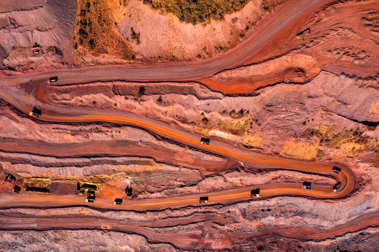 Aerial view of open pit iron ore and heavy mining equipment